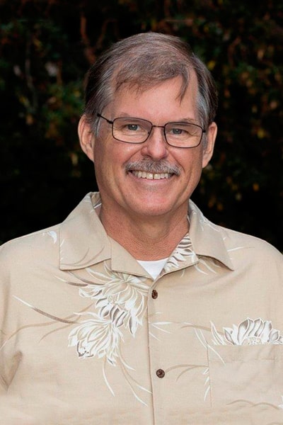 Dr. Charles Harvey smiling in a shirt