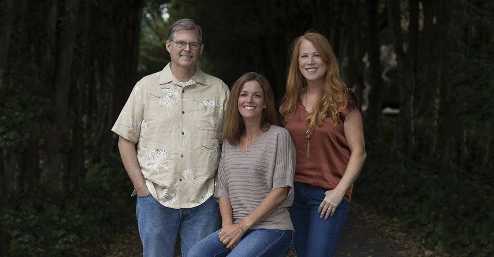 All the members of the Illahee Dental team smiling in a forest