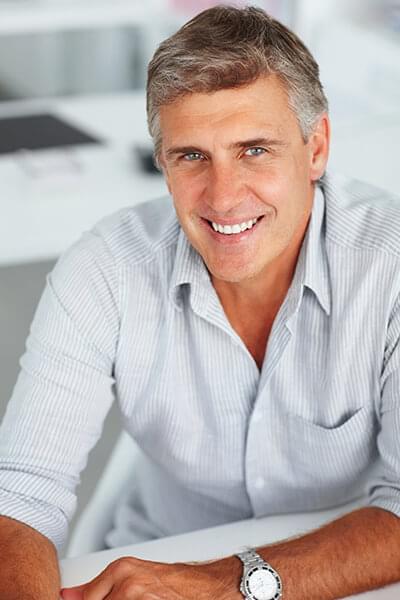 Dental implants can replace your missing tooth A mature man smiling