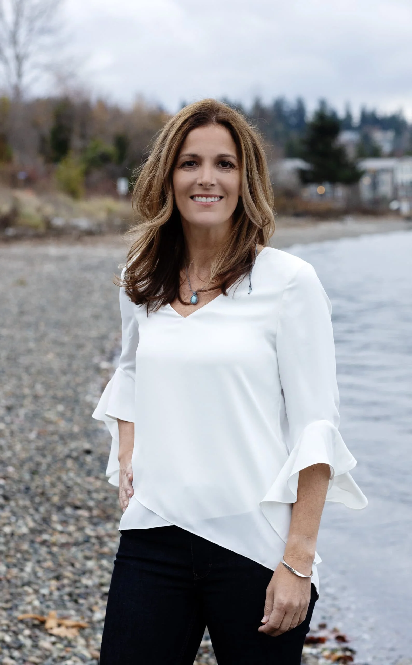 Dr. Lisa Arthur smiling as she leans against a wall